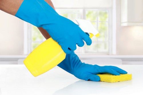 Professional office cleaning team sanitizing shared workspace
