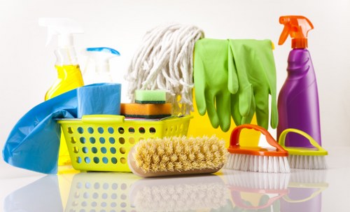 Office cleaning staff disinfecting high-touch surfaces