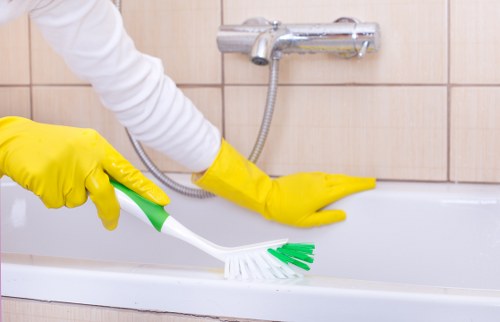 Cleaner disinfecting lift buttons in a communal area
